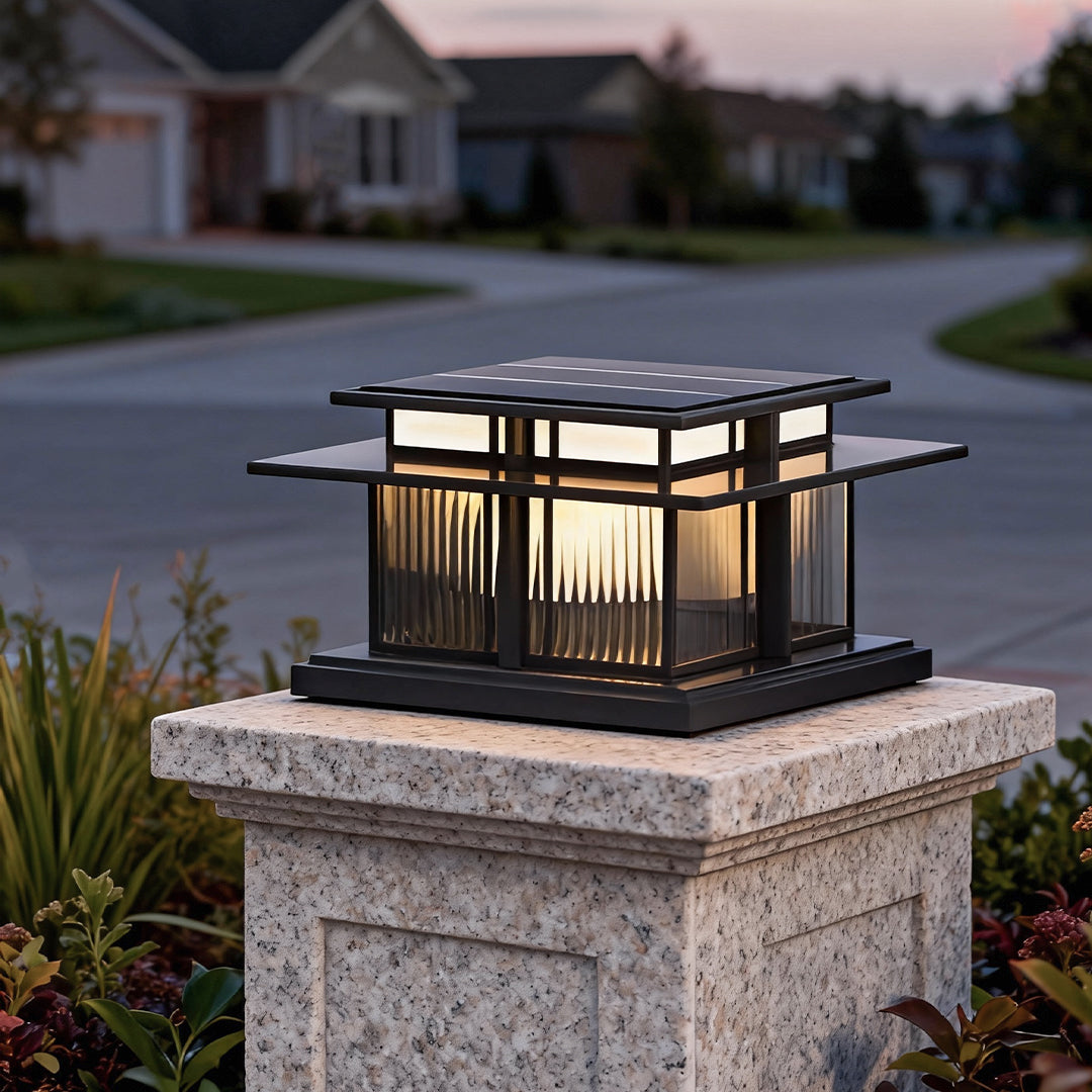 Close up of a black metal porch pillar lights top with integrated solar panel.