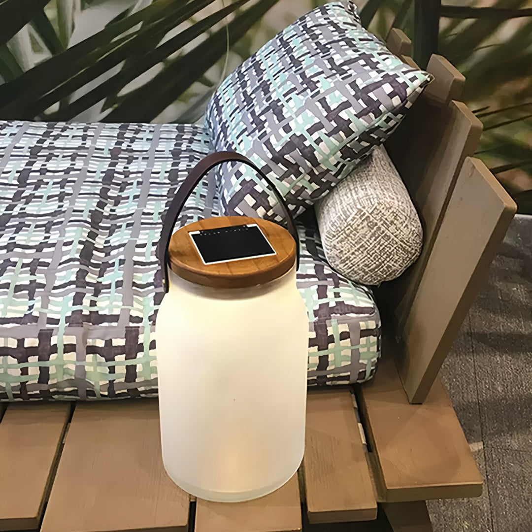 Stylish solar powered camp lantern sitting on outdoor cushions, providing warm decorative lighting.