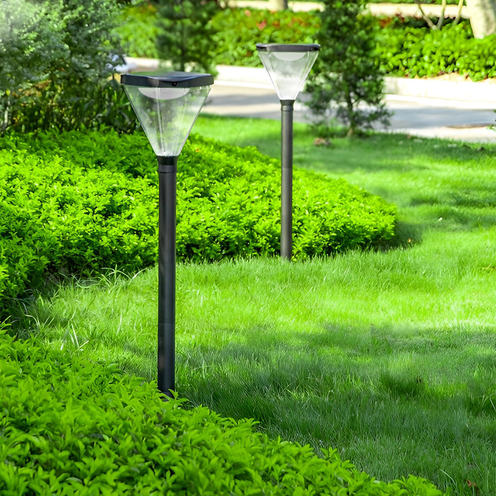 Solar powered lawn light with a minimalist design, installed in a vibrant garden.