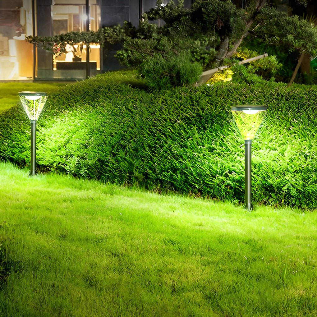 Solar powered lawn light with a sleek black finish, glowing softly in a garden setting.