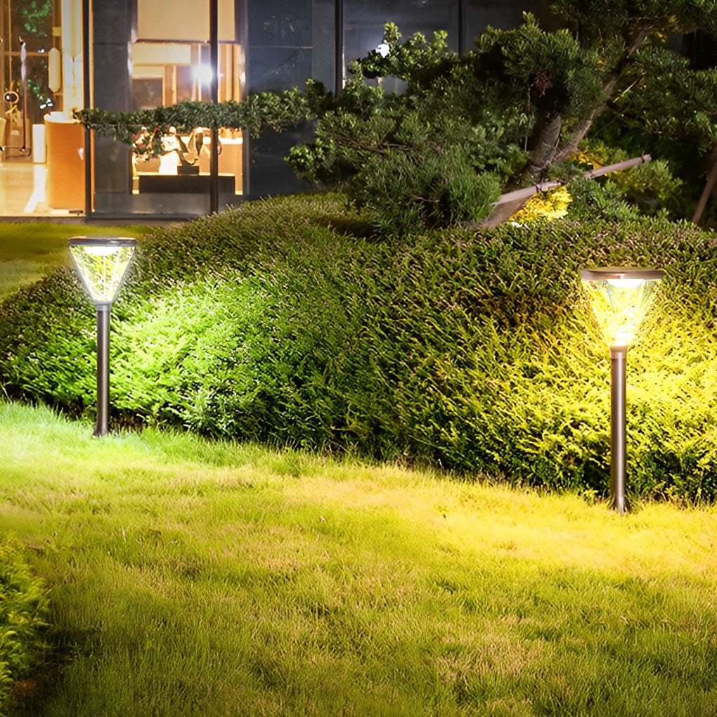 Solar powered lawn lights providing eco-friendly illumination along a grassy pathway.
