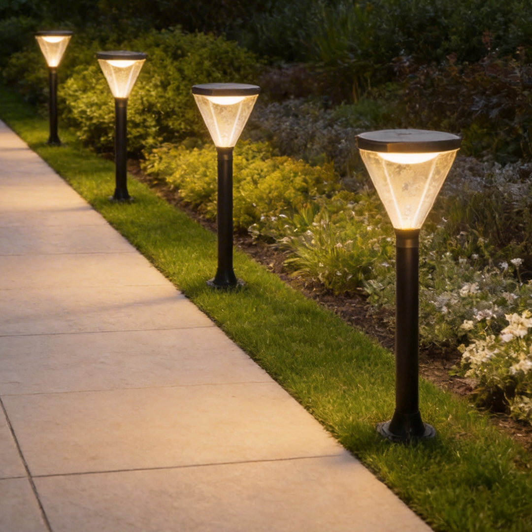Solar powered lawn lights lining a garden pathway, providing soft illumination at dusk.