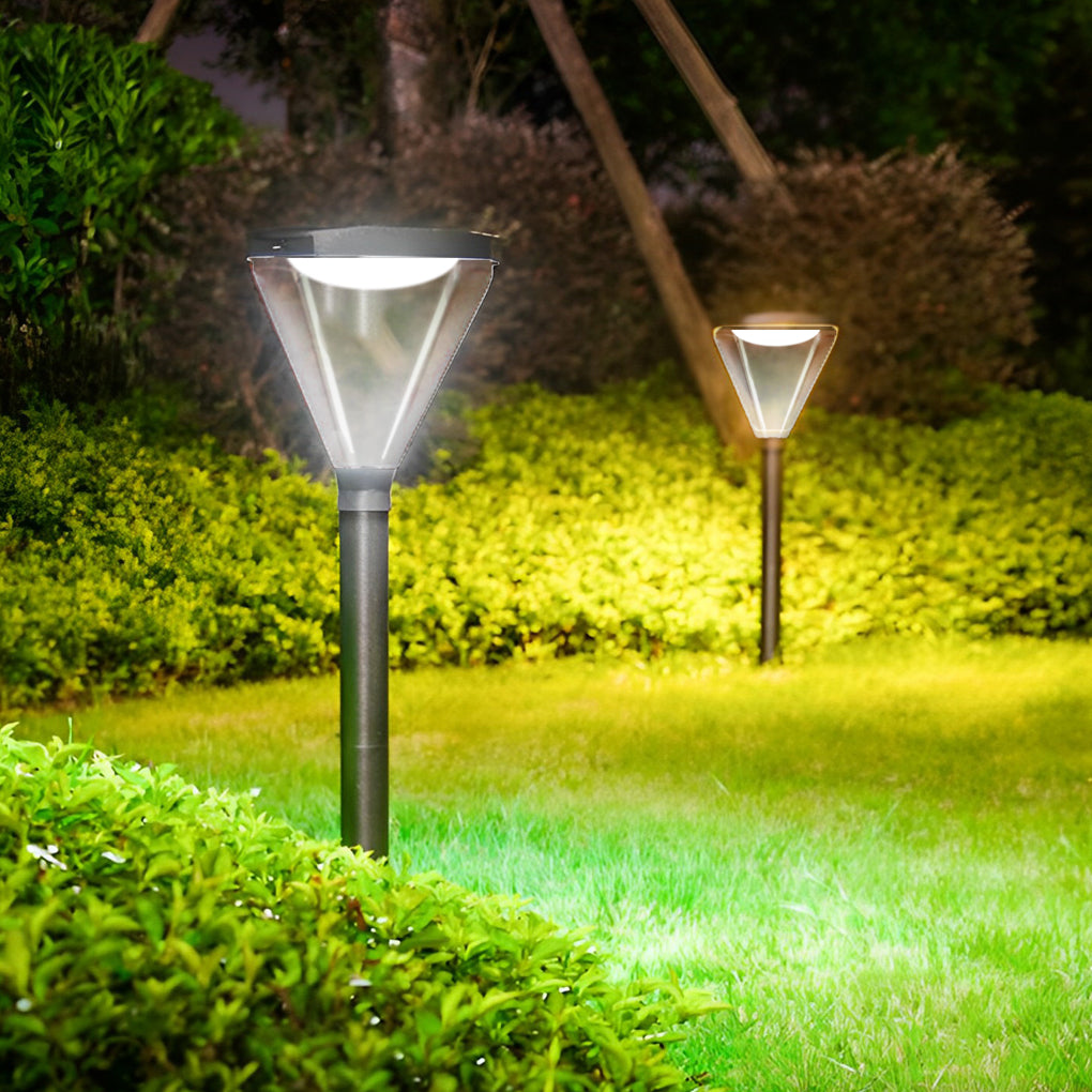 Solar powered lawn lights casting a gentle glow on a garden path at night.
