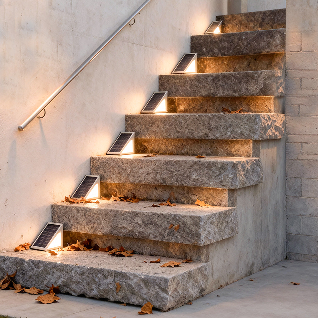 Solar powered lights for steps installed along concrete stairs, providing subtle warm lighting for evening safety.