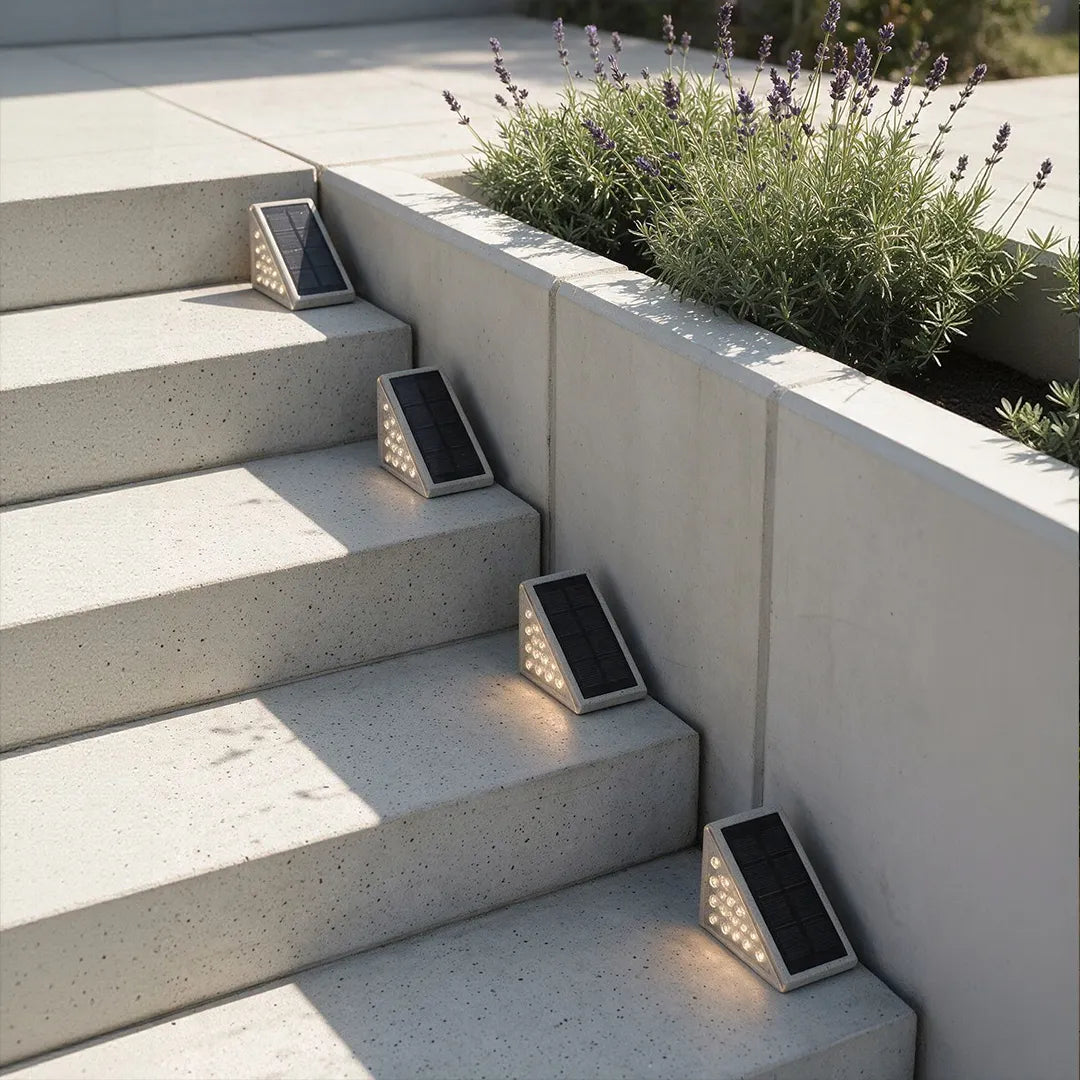 Solar powered lights for steps mounted on concrete stairs, lighting a clean modern entryway.