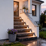 Solar powered lights for steps illuminating a modern outdoor staircase, creating warm and safe pathway lighting at night.