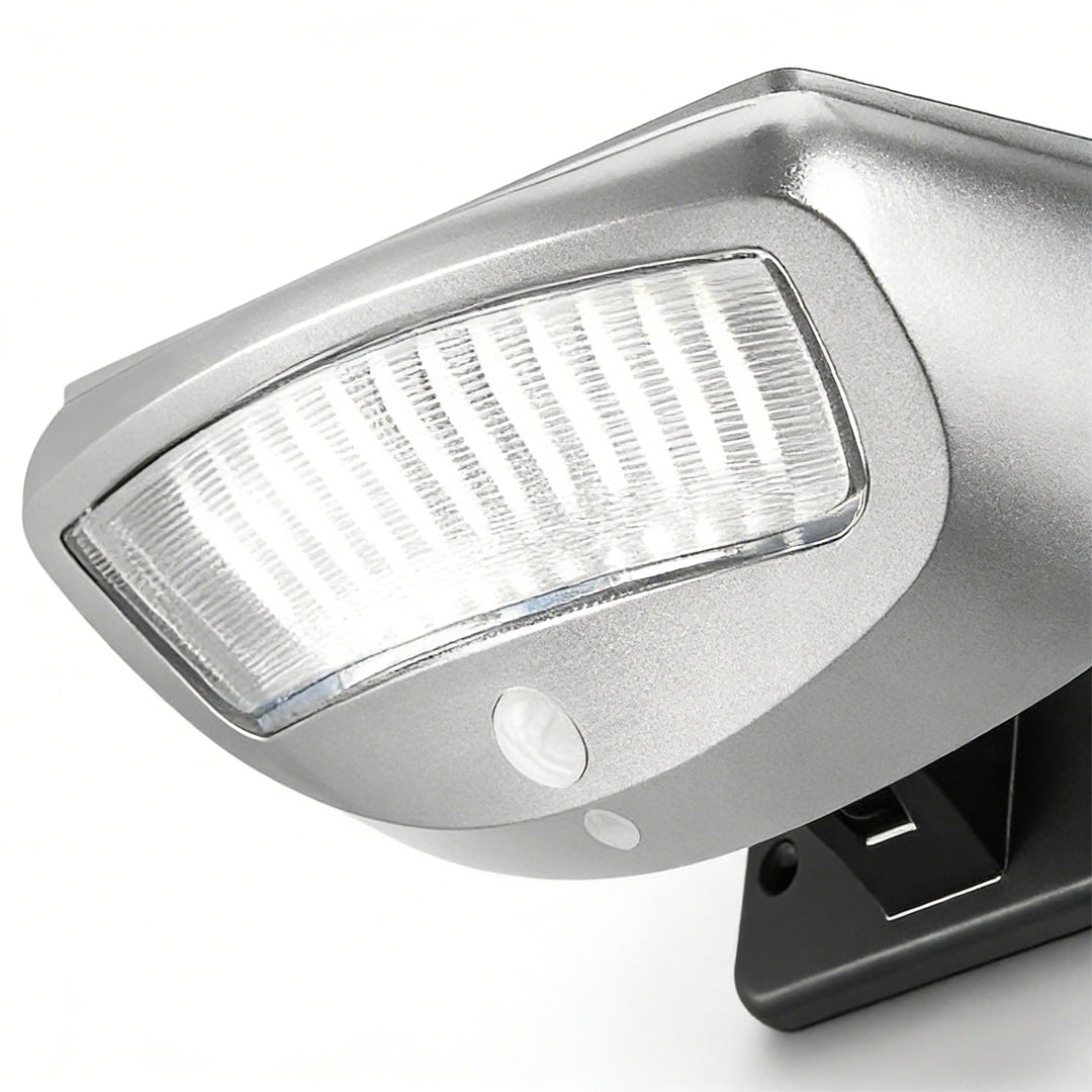 Solar powered motion sensor wall light with a minimalist design, installed on a brick wall.