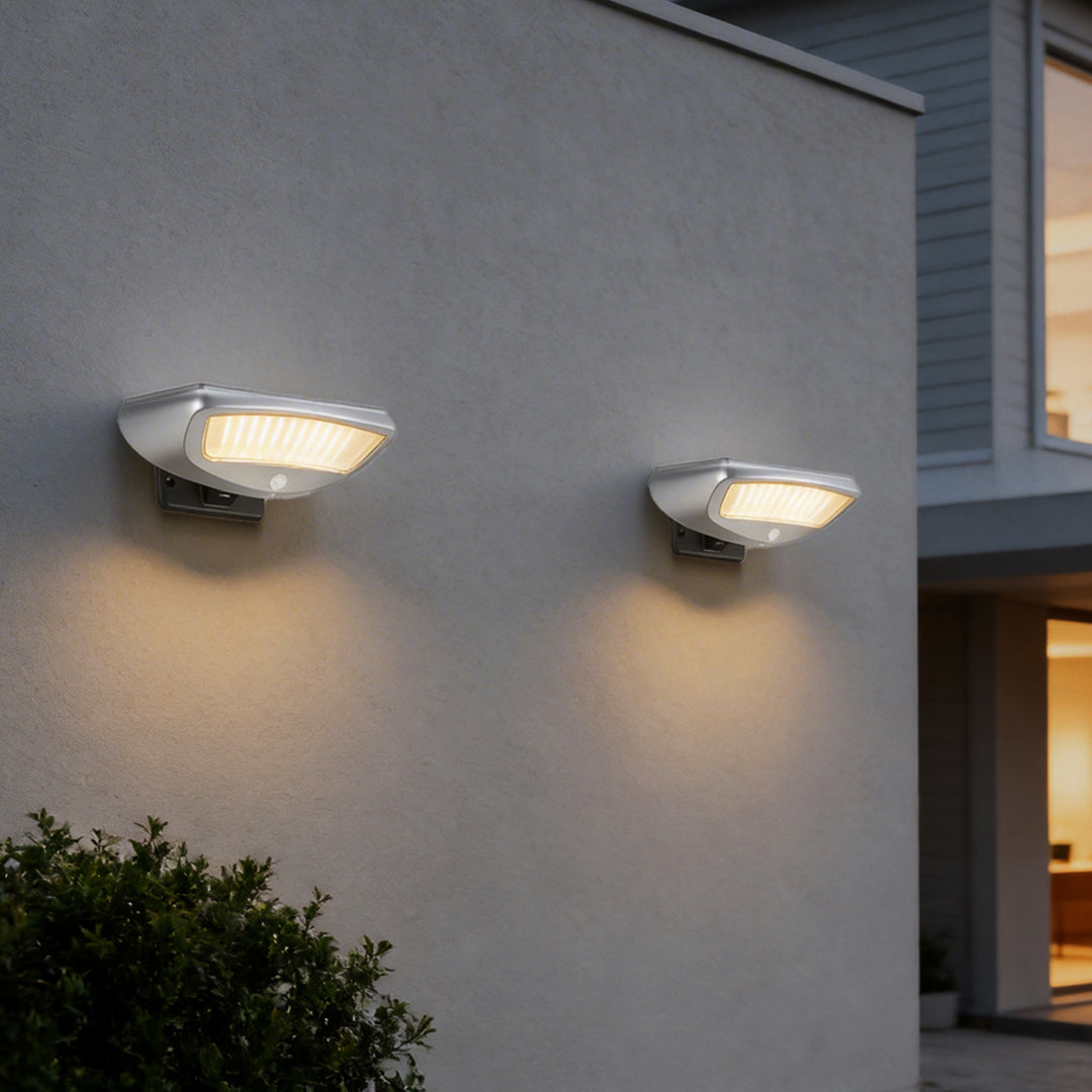 Solar powered motion sensor wall light with a sleek design, mounted on an exterior wall.
