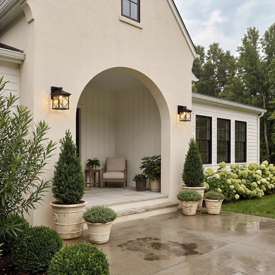 Solar powered outdoor wall sconces mounted along an arched front porch on a Mediterranean-style home exterior.