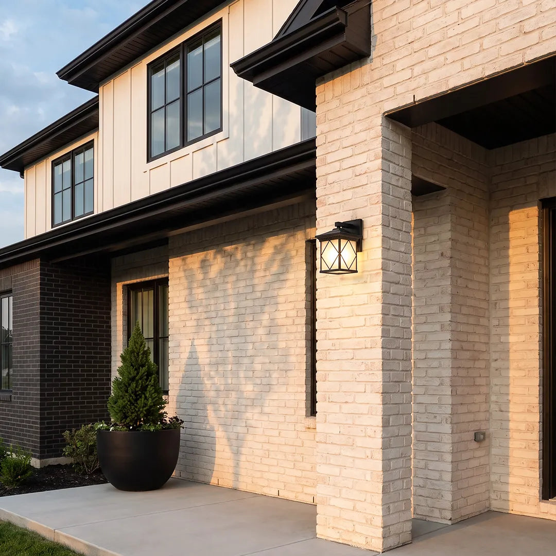 Solar powered outdoor wall sconces installed on a modern brick home exterior beside a garage.