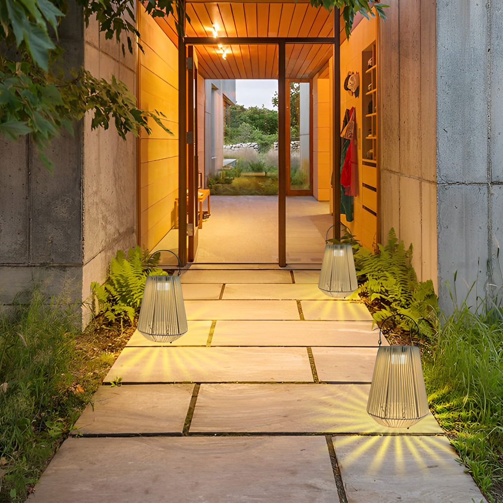Solar rope lanterns arranged along a modern entry path creating warm nighttime guidance lighting.