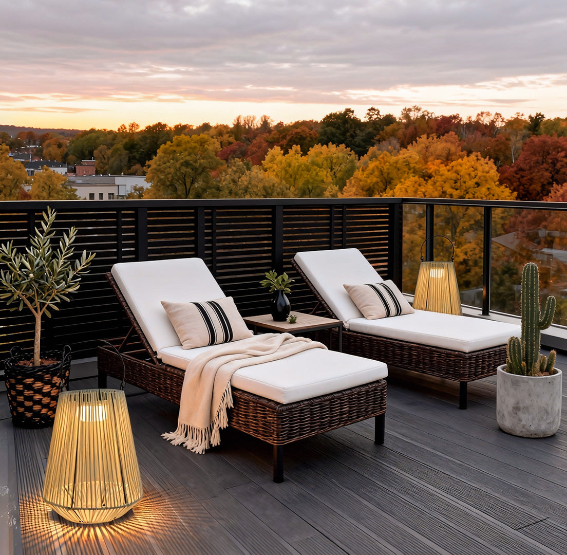 Solar powered rope lantern placed beside outdoor lounge chairs on a modern rooftop deck at sunset.