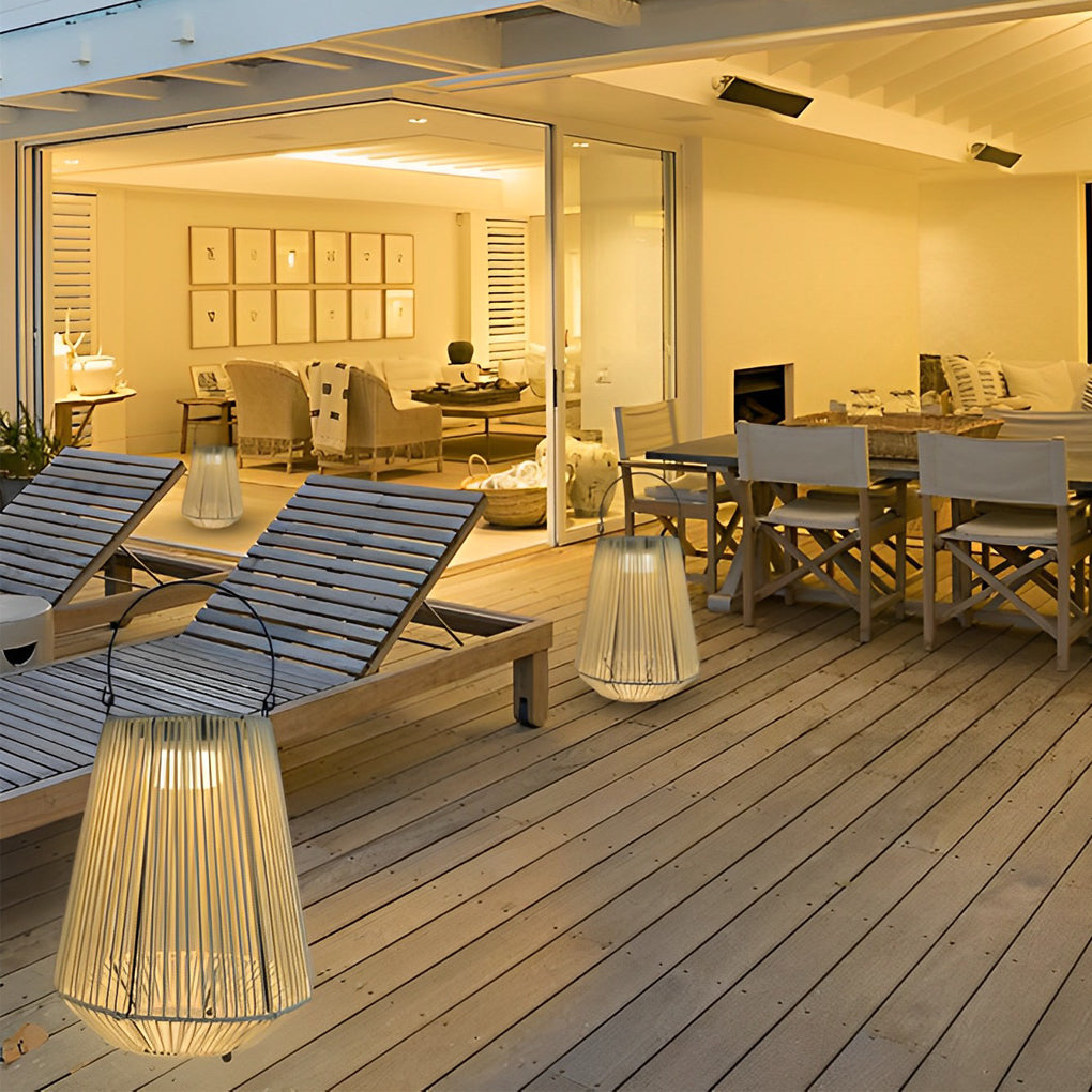 Solar rope lantern illuminating a wooden terrace dining area with modern outdoor seating.