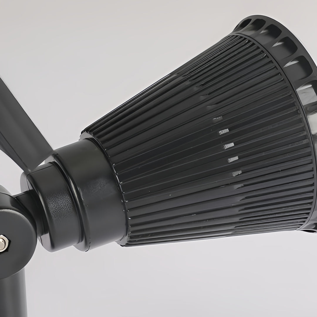Close-up of solar powered spotlights housing showing textured black aluminum body and adjustable mounting joint.