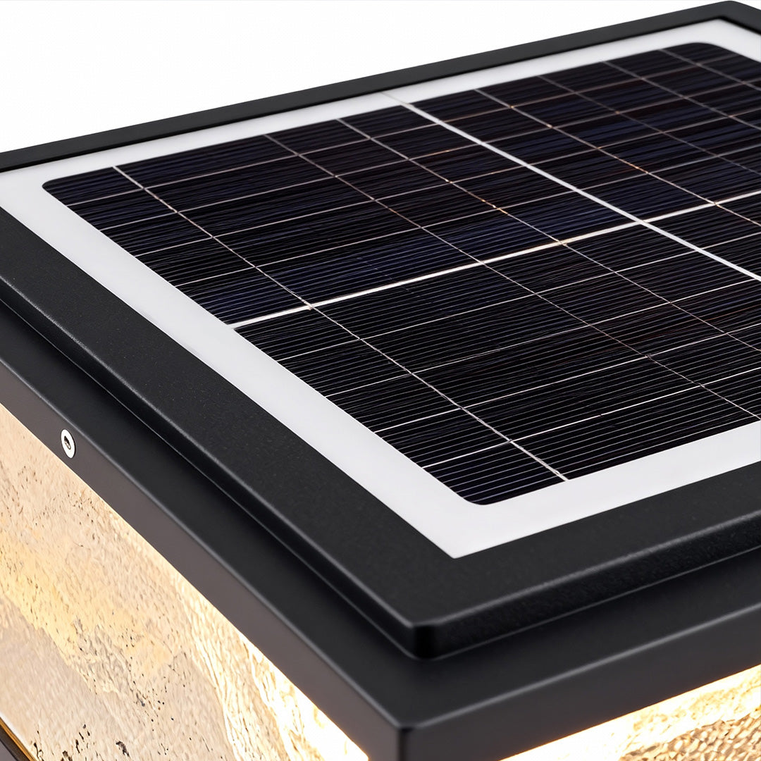 Solar panel detail on top of square outdoor pillar lights.