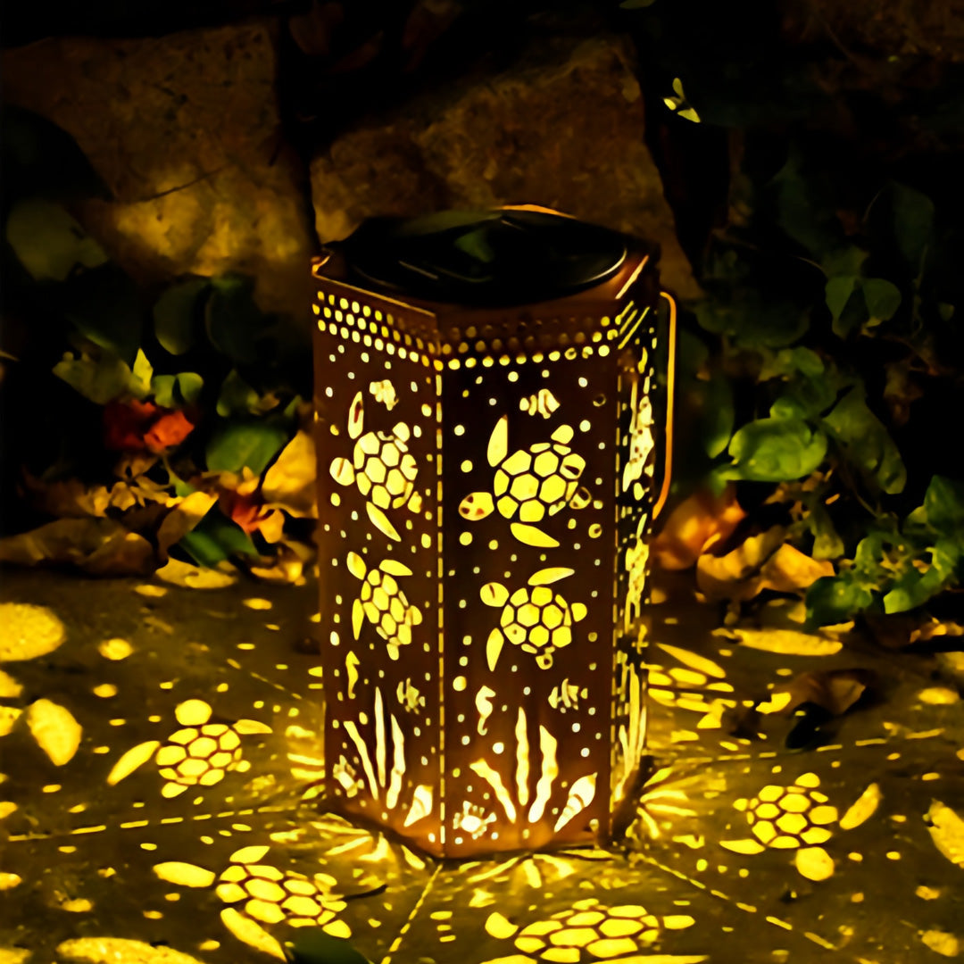 Solar powered red outdoor lantern featuring turtle and plant patterns for garden walkway decoration.