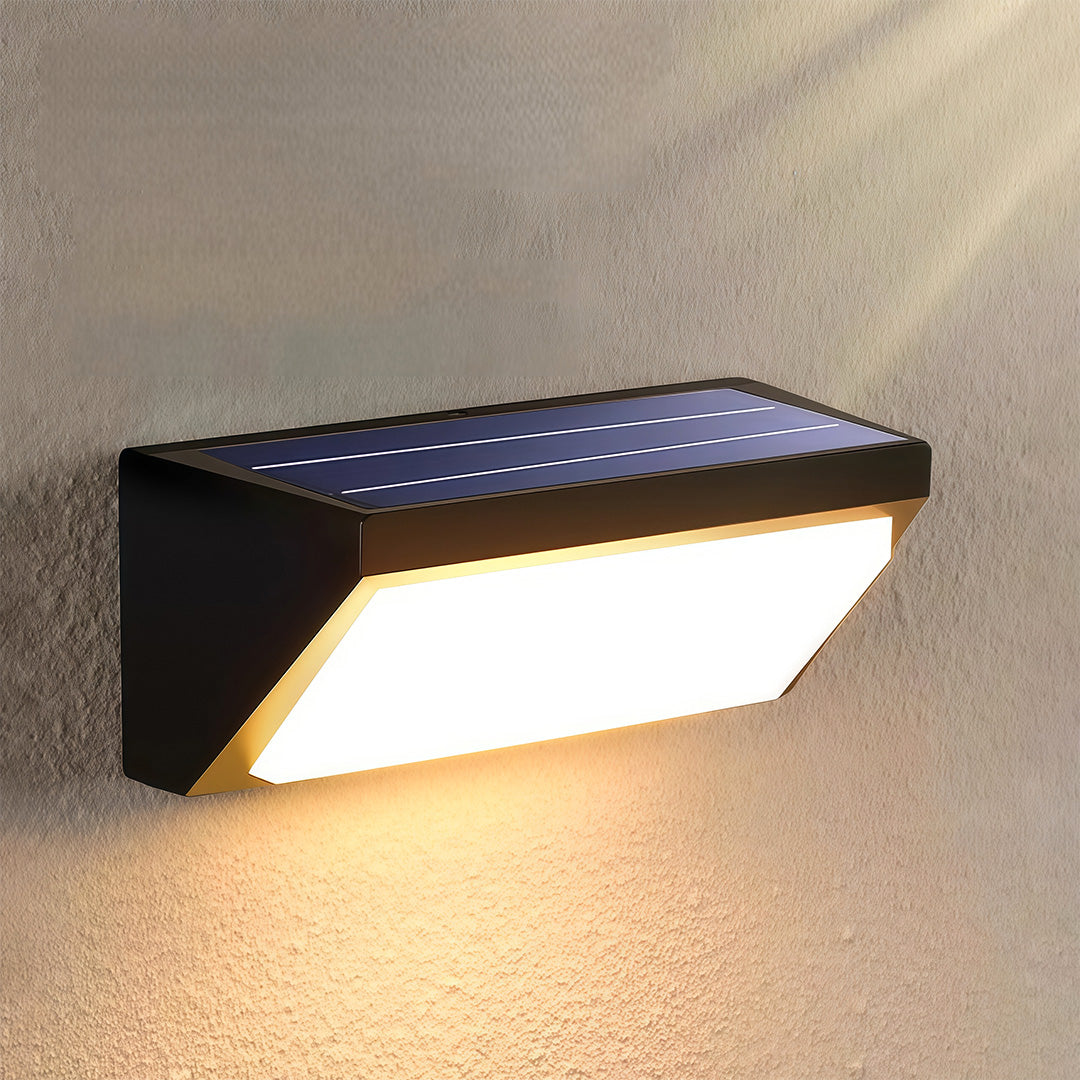Solar outdoor wall light mounted on a white exterior, providing energy-efficient lighting to a contemporary home.