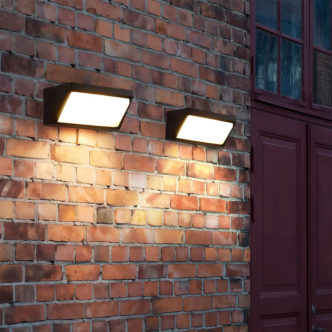 Outdoor solar wall mount light with a soft, ambient glow, mounted on a red brick wall to enhance the outdoor ambiance.
