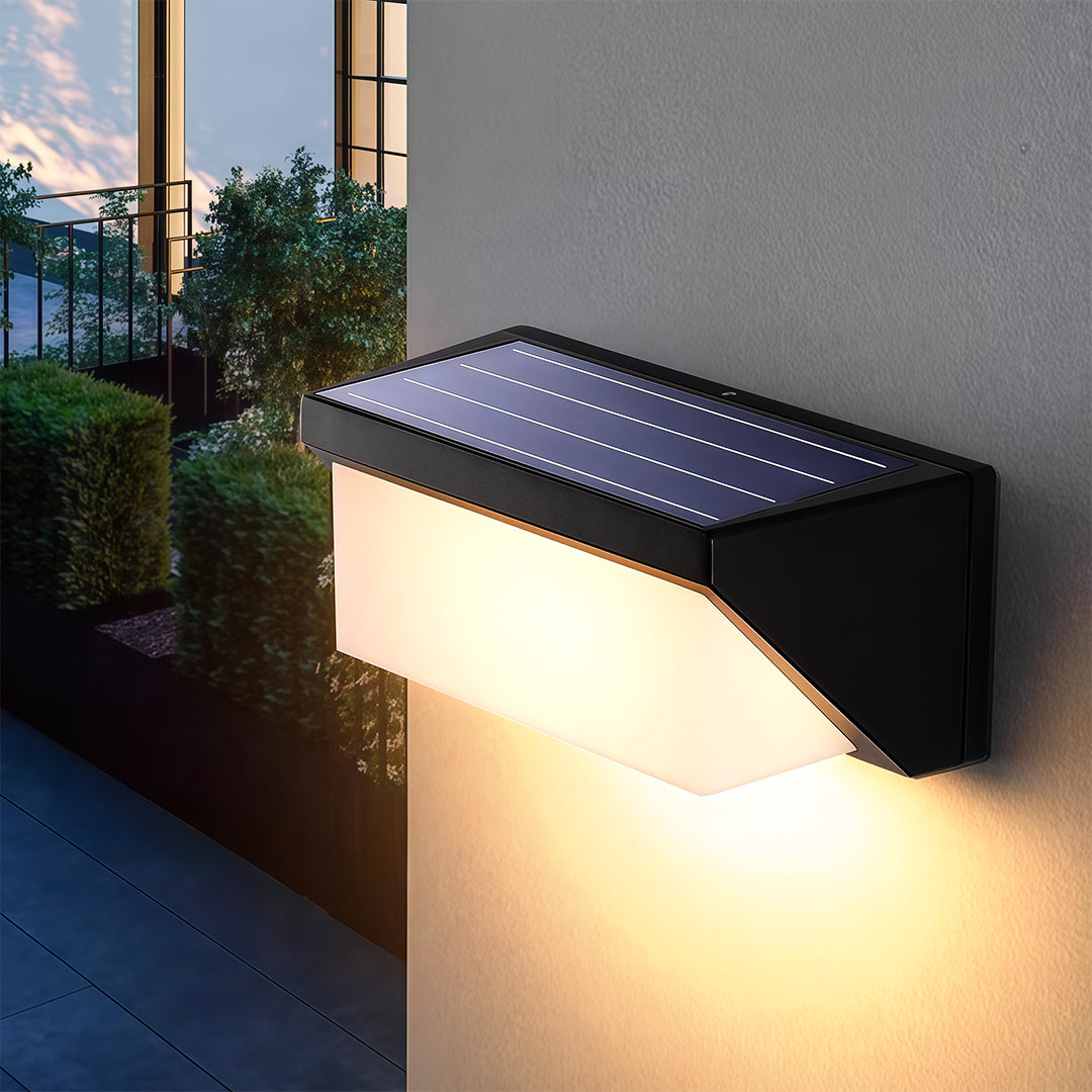 Bright solar-powered wall mount light on a modern exterior wall, enhancing the garden's ambiance with a warm glow.