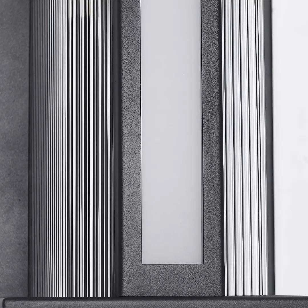 Solar wall sconce with ribbed black metal frame and frosted glass diffuser