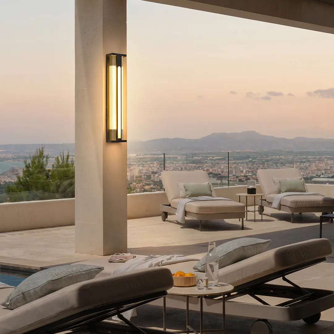Solar wall sconce illuminating luxury terrace lounge with scenic sunset view