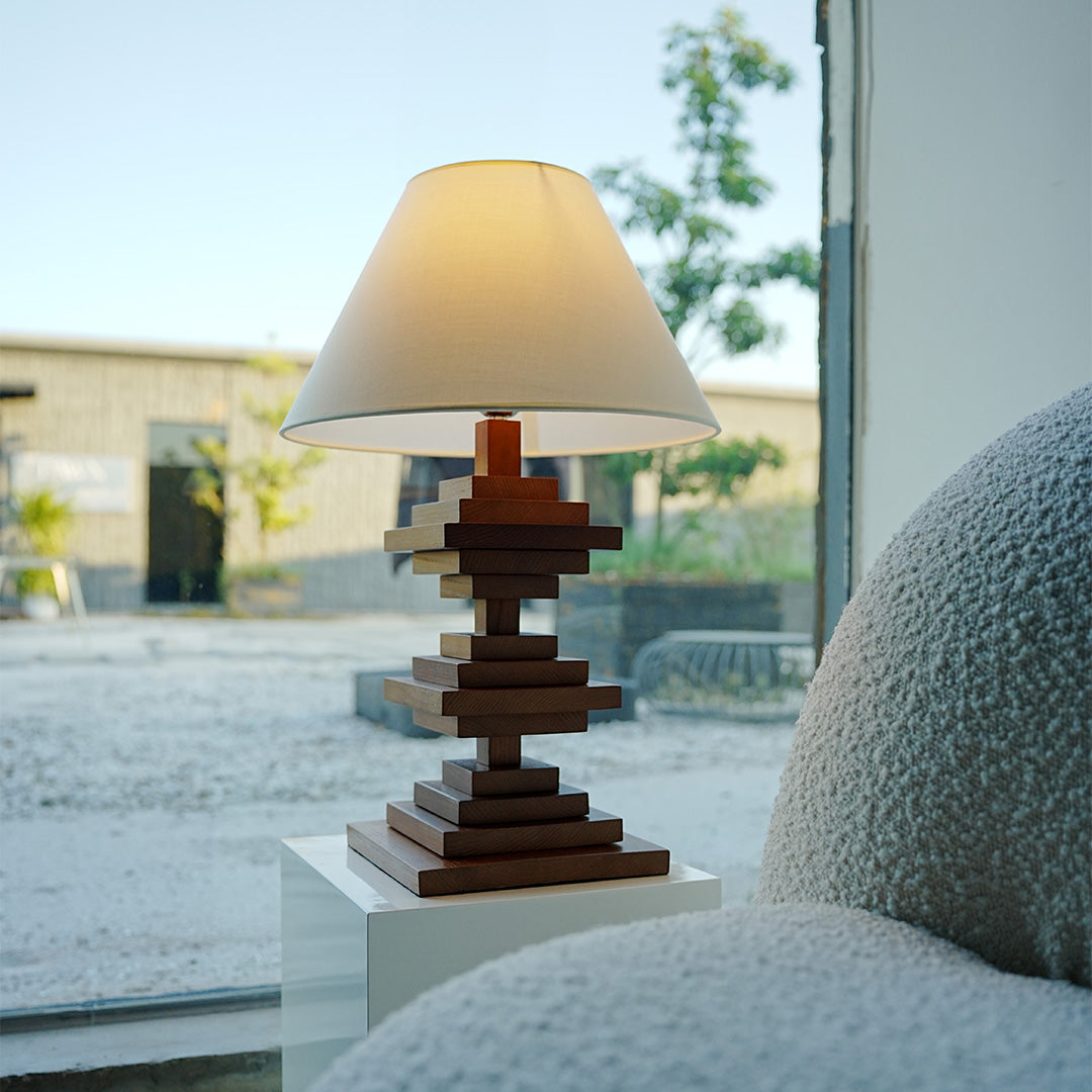 Solid wood table lamps with natural finish illuminating cozy living room.