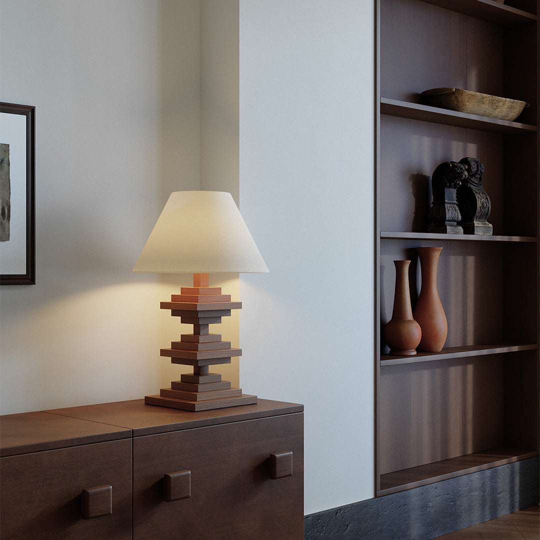 Solid wood table lamps with beige shade blending into modern shelf corner.