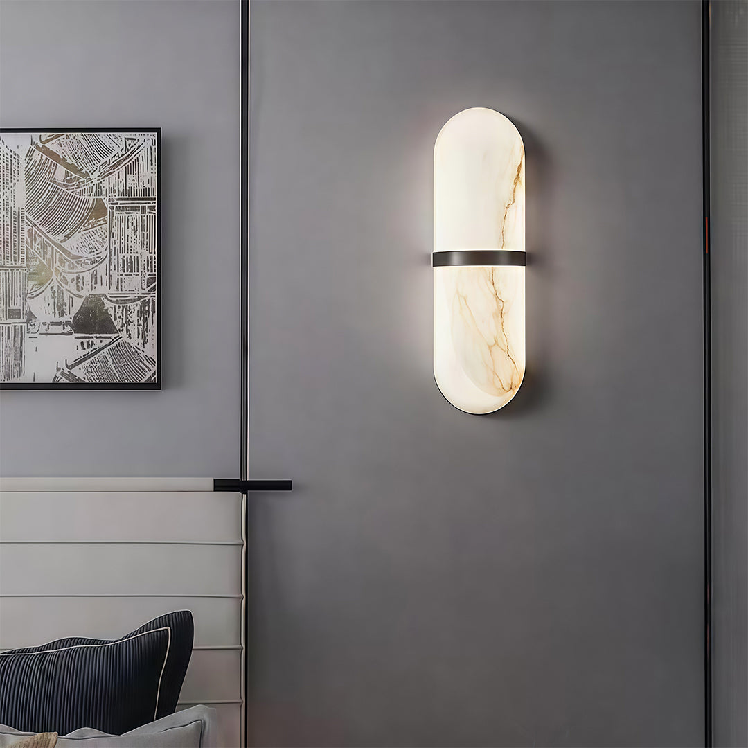 Sophisticated art wall lighting with glass shade chandelier influence providing ambient lighting in contemporary bedroom with artwork.