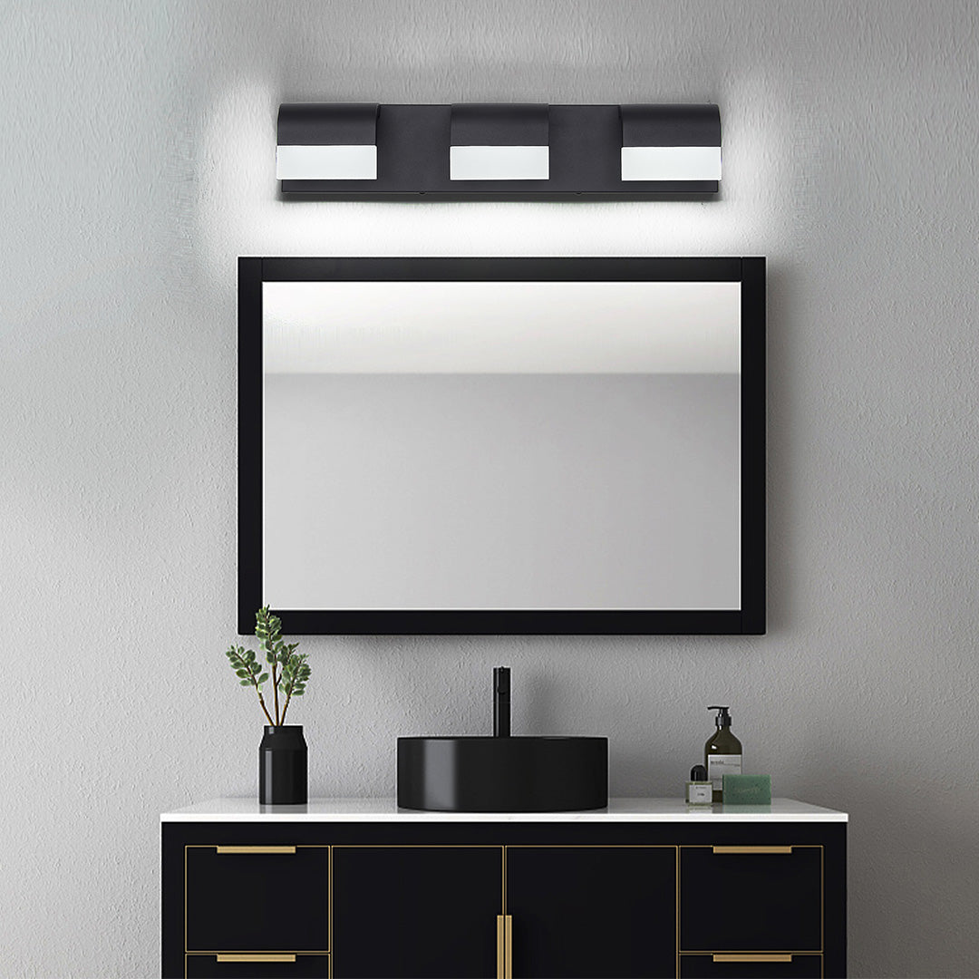Sophisticated black vanity lighting for bathroom featuring glass shade chandelier style three-light bar above contemporary vanity.