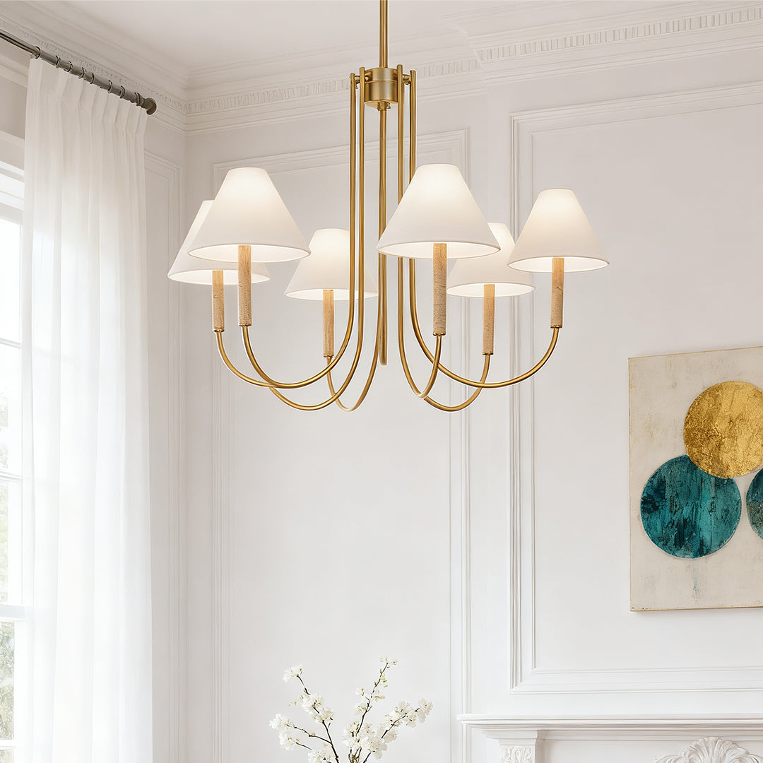 Elegant living area with high ceilings and a sophisticated cloth shade chandelier illuminating a white mantelpiece and wall art.