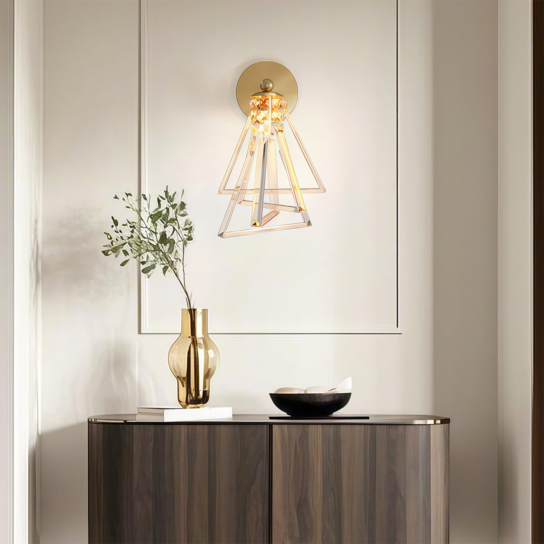 Sophisticated crystal wall lights with glass shade chandelier influence illuminating modern entryway with gold hardware and cascading crystals.