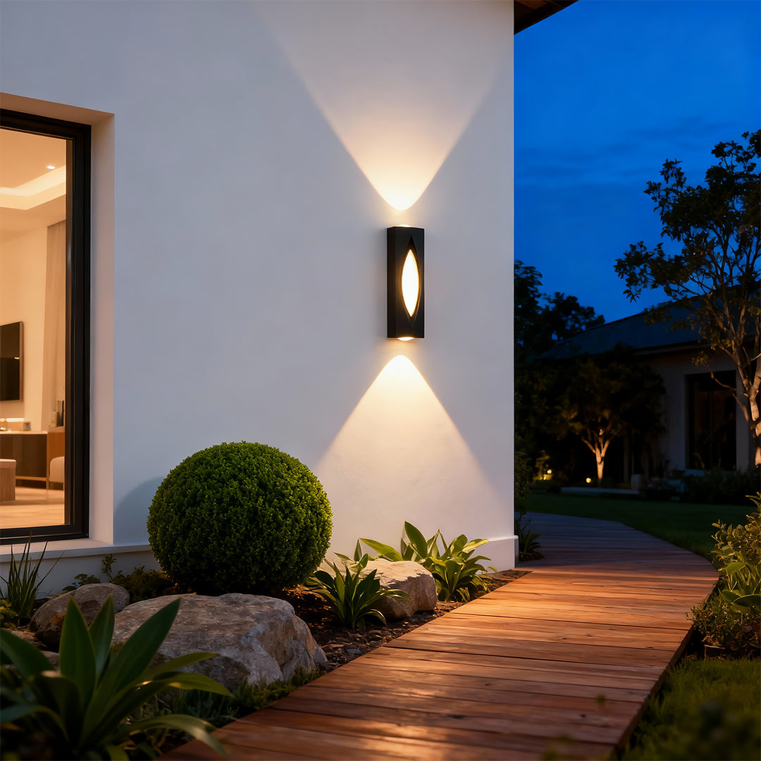 Sophisticated decorative wall sconce lighting featuring glass shade chandelier influence with striking bidirectional light at dusk.