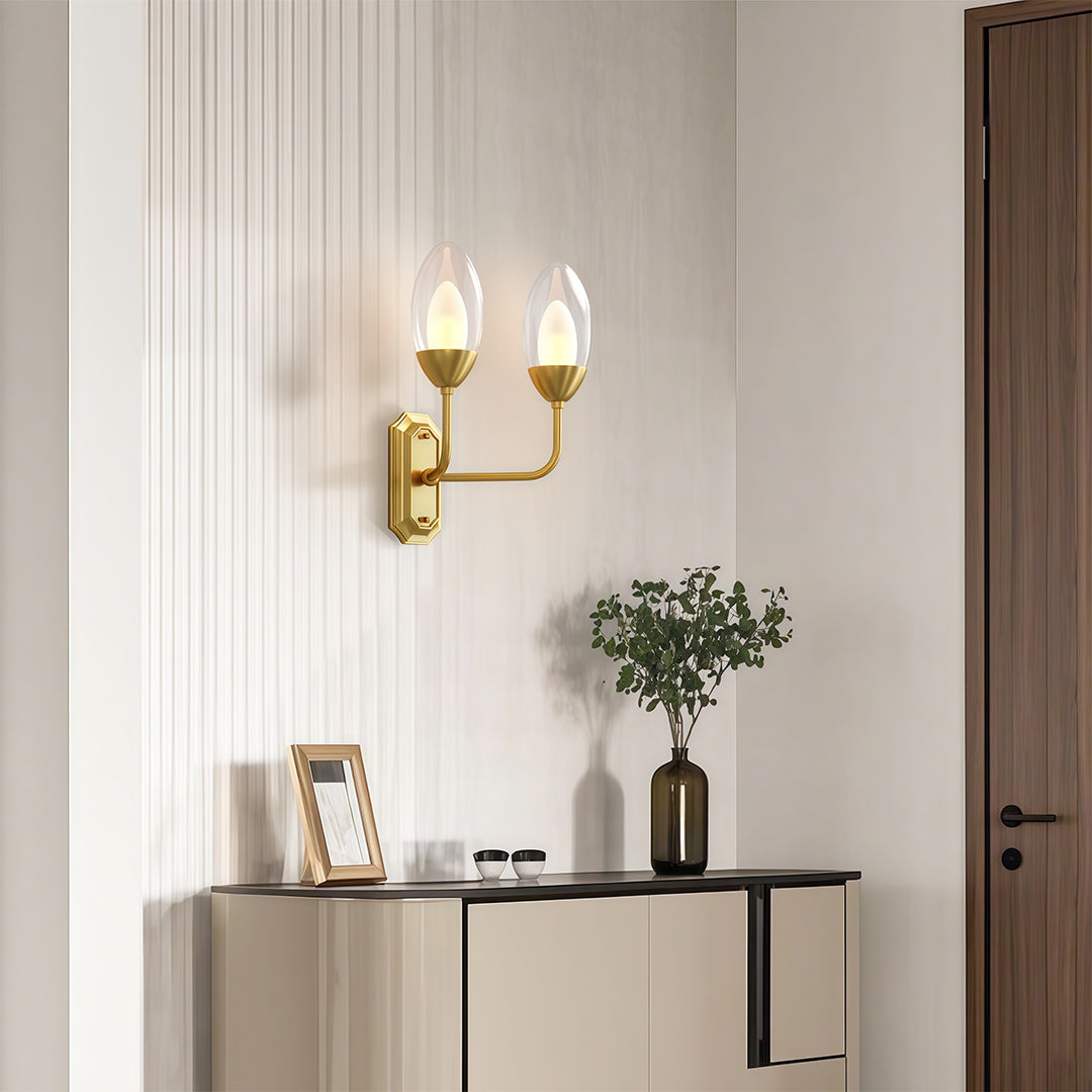Sophisticated glass wall light with glass shade chandelier influence illuminating modern entryway with warm ambient glow.