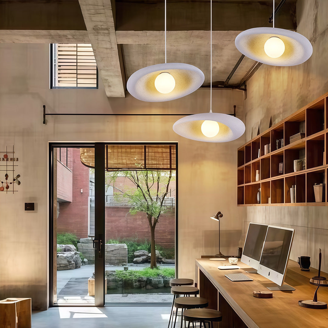 Sophisticated Japanese pendant lights featuring glass shade chandelier influence creating ambient lighting over dining area.