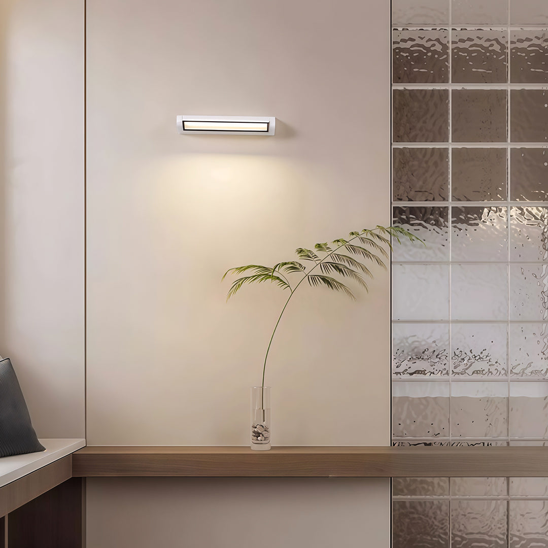 Sophisticated LED light bar for wall with glass shade chandelier design providing focused illumination above bed in modern bedroom.