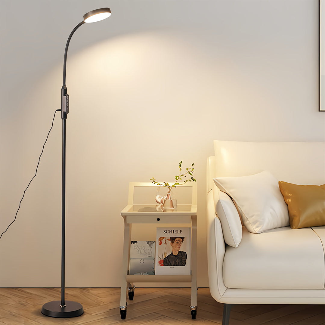 Sophisticated led reading floor lamp beside comfortable chair creating perfect reading environment