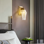 Sophisticated LED wall sconce lights featuring glass shade chandelier influence creating warm glow in modern bathroom setting.
