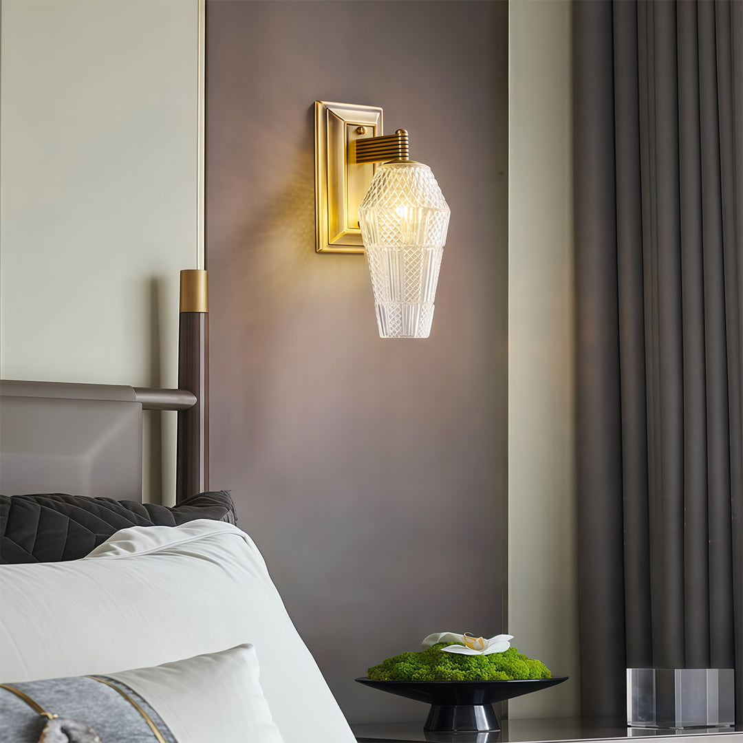 Sophisticated LED wall sconce lights featuring glass shade chandelier influence creating warm glow in modern bathroom setting.
