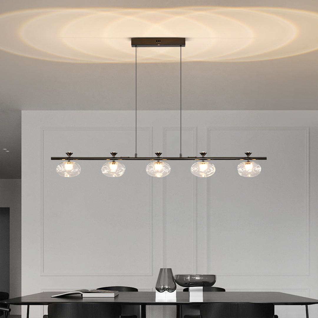 Sophisticated linear glass chandelier featuring clear spheres in minimalist kitchen setting