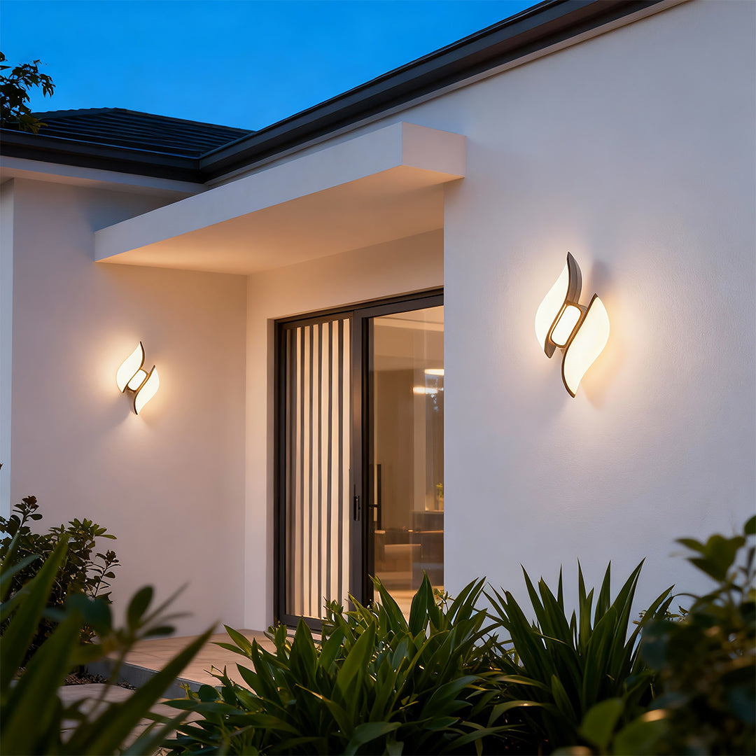 Sophisticated paired black outdoor wall sconces featuring glass shade chandelier influence on modern white exterior facade.