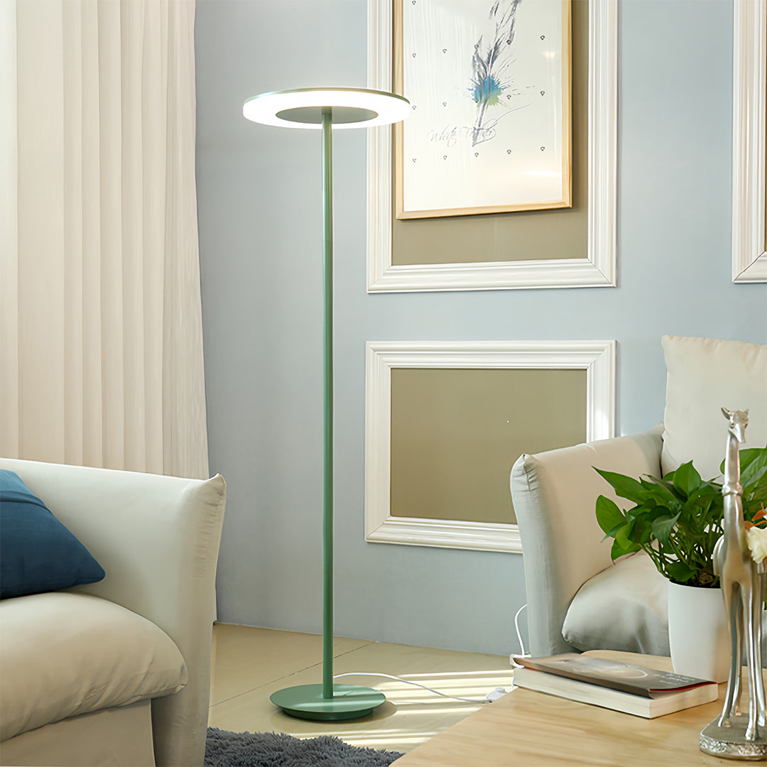 Sophisticated colored floor lamp in teal creating ambient lighting in stylish modern living room