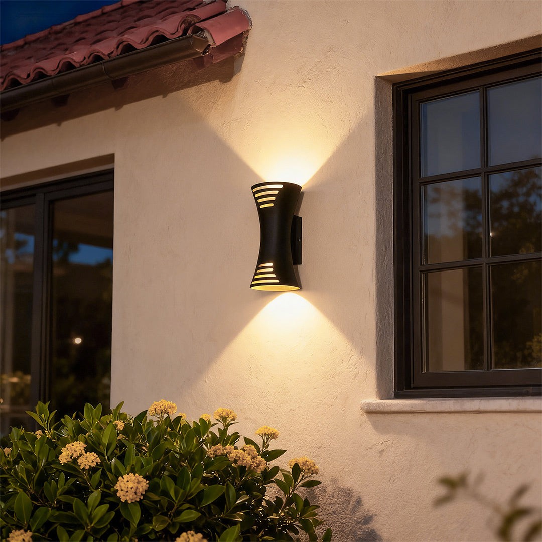 Sophisticated up down lighting wall sconce featuring glass shade chandelier influence with striking bidirectional illumination pattern.