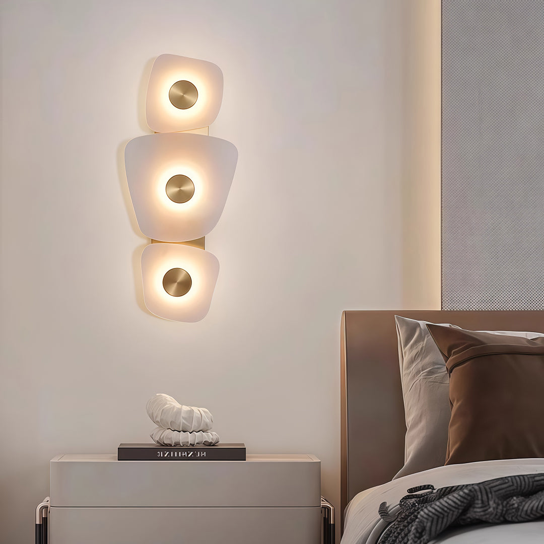 Sophisticated wall art lighted with glass shade chandelier influence providing decorative accent above bed in contemporary bedroom.