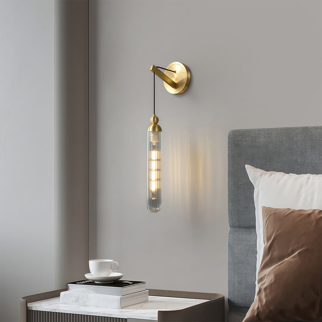 Sophisticated wall mount pendant light with glass shade chandelier influence illuminating bedroom nightstand with warm ambient glow.