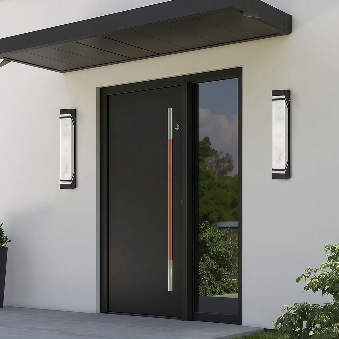 Sophisticated wall mounted exterior lights with glass shade chandelier design flanking contemporary garage entrance at twilight.