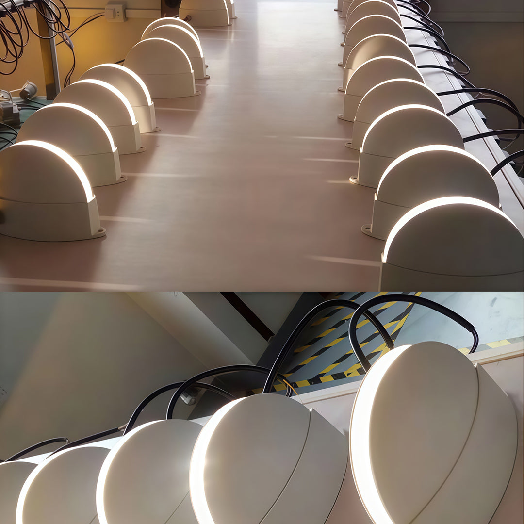 Sophisticated white outdoor wall lights featuring glass shade chandelier influence in minimalist dome configuration for uniform illumination.