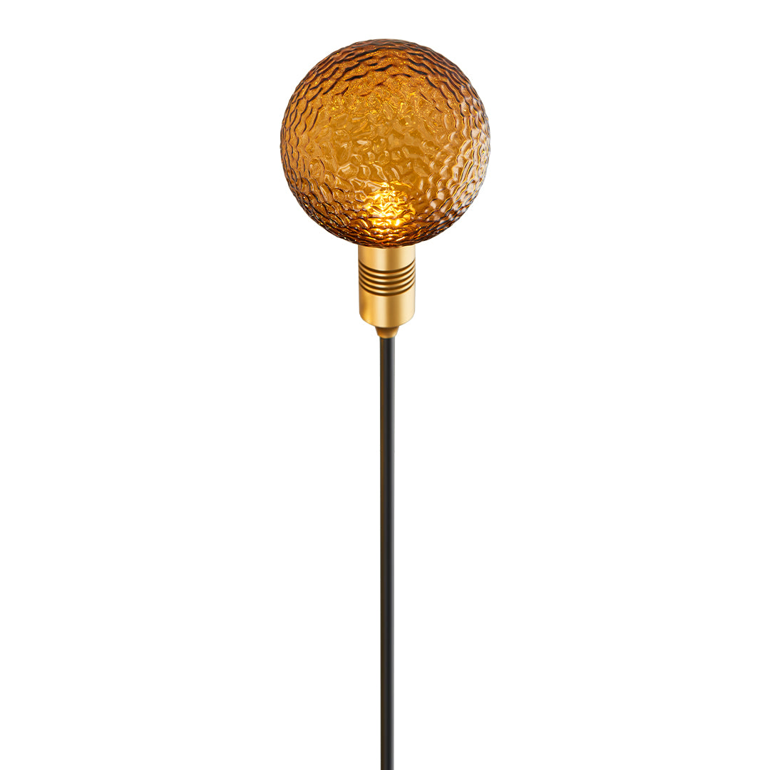 Sparkling gold globe garden stake providing warm ambient path landscape lighting.