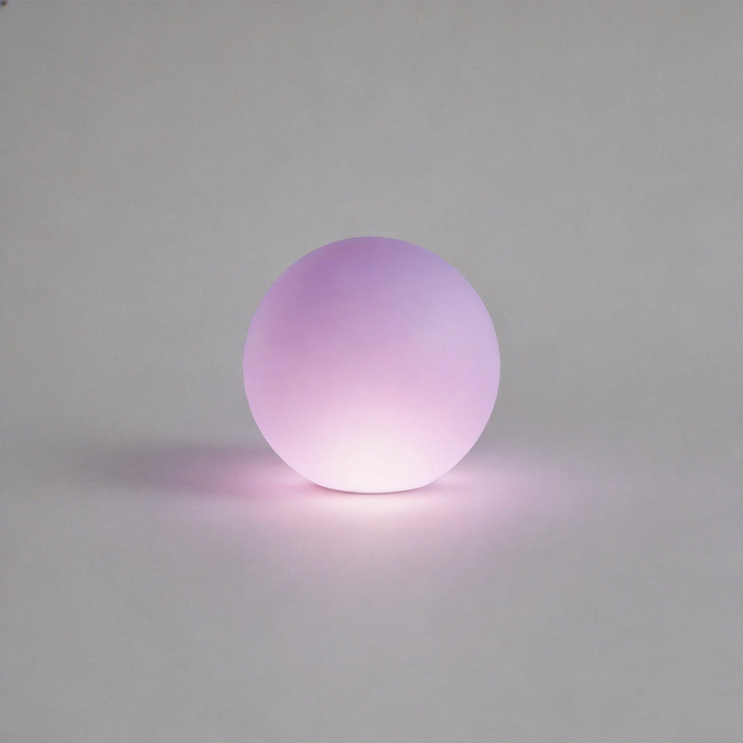 Sphere floor lamp close-up showing smooth frosted globe lighting detail.