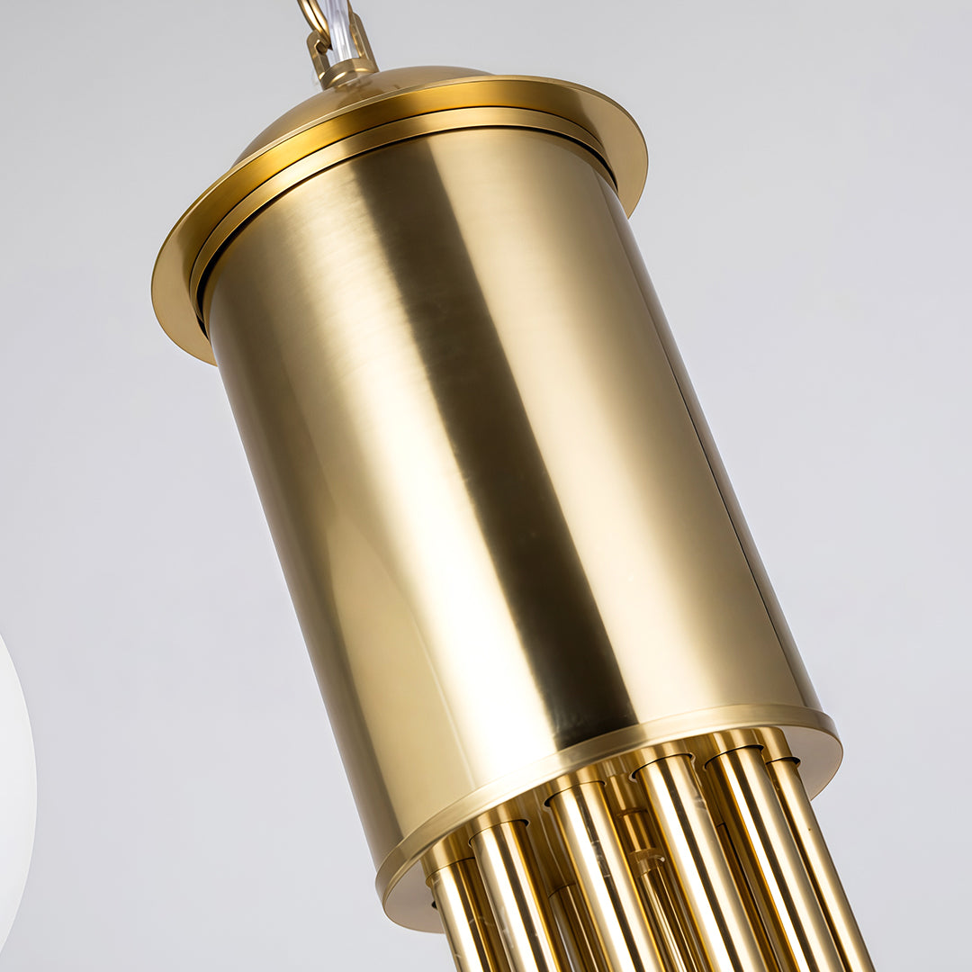 Close-up of the chandelier’s polished brass cylinder body showing premium metal texture