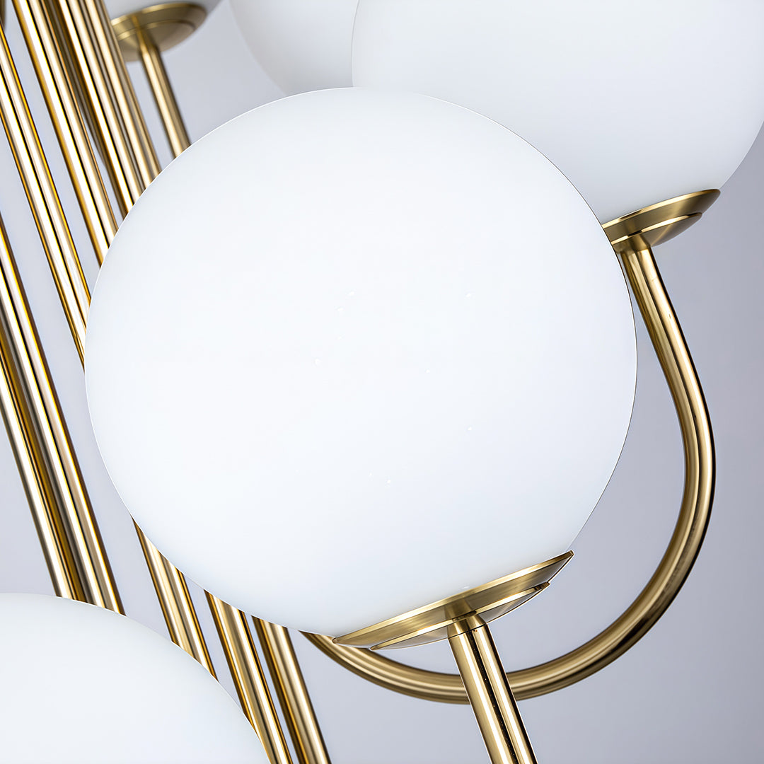 Elegant spiral globe chandelier featuring white frosted glass shades and golden metal arms